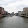 A canal in Hamburg, Germany with buildings and a waterfront promenade